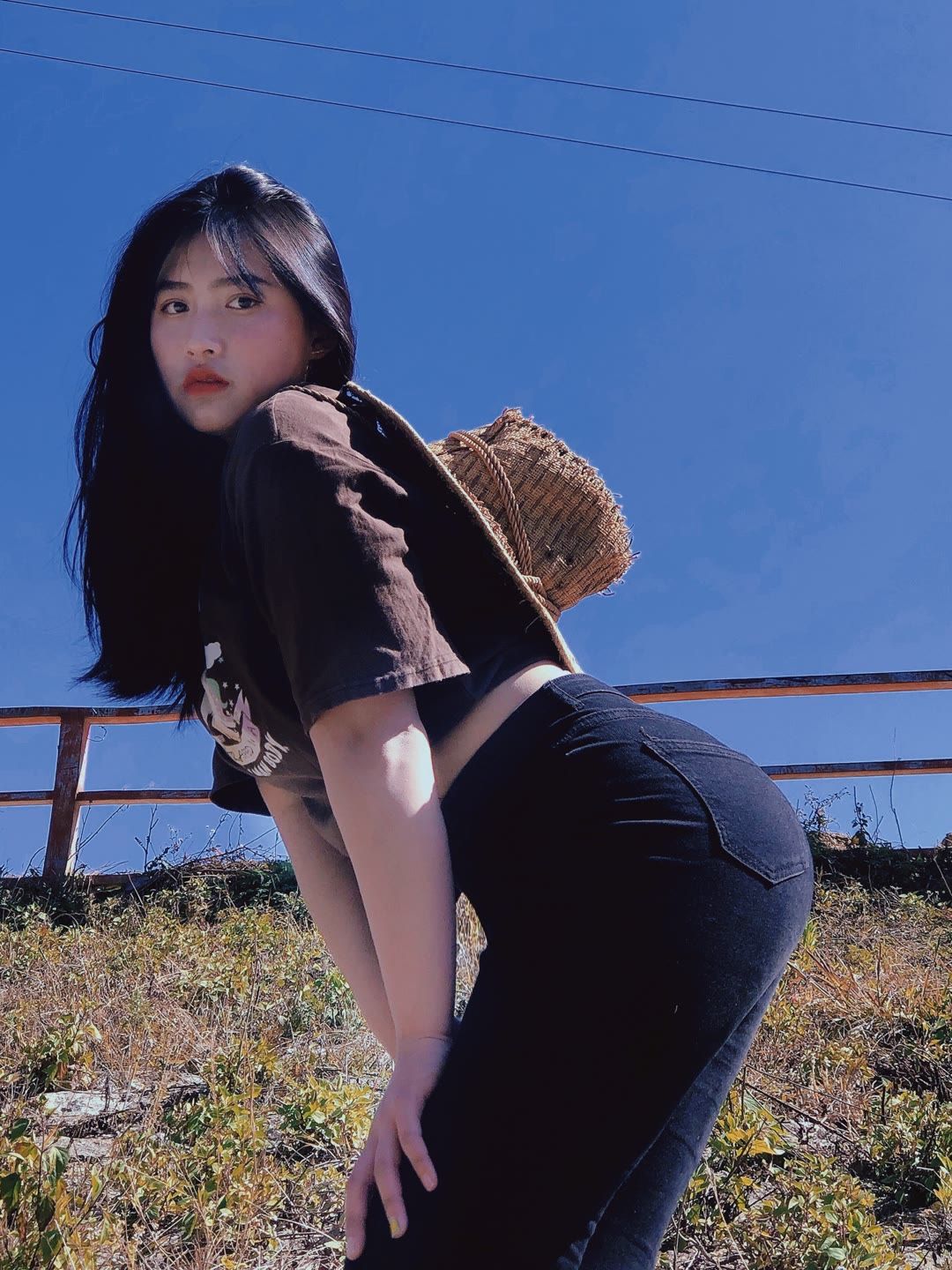 蓝天下漂亮的牛仔裤美女